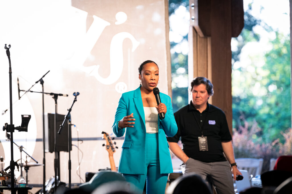 Speakers, Fawn Weaver and Mateas Bentel, on stage at the Spirits on the Rise Summit